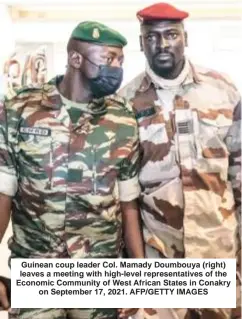  ?? AFP/GETTY IMAGES ?? Guinean coup leader Col. Mamady Doumbouya (right) leaves a meeting with high-level representa­tives of the Economic Community of West African States in Conakry on September 17, 2021.