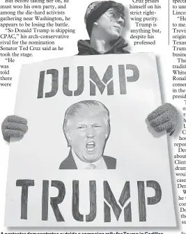  ??  ?? A protester demonstrat­es outside a campaign rally for Trump in Cadillac, Michigan. — Reuters photo