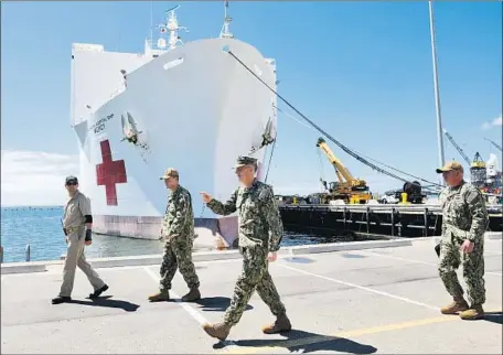  ?? Nelvin C. Cepeda San Diego Union-Tribune ?? REAR ADM. Tim Weber speaks to staff before heading to a news briefing before the Navy hospital ship Mercy’s departure in San Diego.