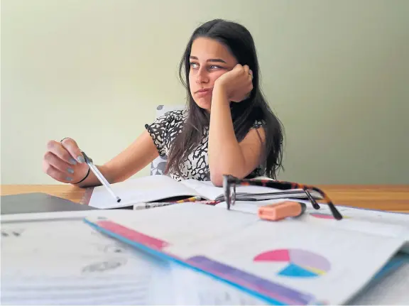  ??  ?? Isla Stanton,13, settles into her work at home as schools across the UK remain closed to prevent the spread of coronaviru­s.