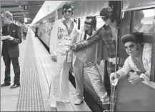  ?? PETER PARKS / AFP ?? Elvis fans arrive at Central station before boarding a train to The Parkes Elvis Festival, in Sydney, on Thursday.