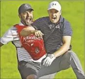  ?? GETTY ?? Jordan Spieth celebrates with caddie Michael Greller after chipping in for birdie from bunker on 18th green to win Travelers Sunday.