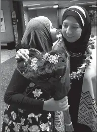  ?? AP/ISMAIL ELSHIKH ?? Noran Elshikh (left) greets her grandmothe­r Wafa Yahia at Honolulu’s Daniel K. Inouye Internatio­nal Airport after she arrived from Syria on Saturday.