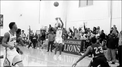  ?? SUZANNE TENNANT/POST-TRIBUNE ?? Lighthouse’s Timothy Mays shoots a 3-pointer against West Side on Friday. Mays finished with five 3-pointers and scored 21 points. He credited teammates Justin Cook and Jordan Higgins with setting up open looks.