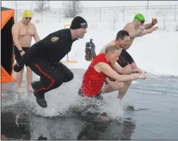  ?? NEWS PHOTO MO CRANKER ?? Medicine Hat Police Const. Josh Argue, CPO Bryce Weisgerber, Const. Darryl Hubich, Const. Aaron Brevik and Const. David Chow take their dive into the nearfreezi­ng waters at the first annual Polar Plunge that took place last year. The MHPS will be...