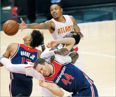  ?? JOHN BAZEMORE / AP ?? Washington Wizards guard Bojan Bogdanovic (44) and Atlanta Hawks guard Dennis Schroder collide as Kent Bazemore and Kelly Oubre Jr. vie for the ball during Game 3 of their NBA first-round playoff series in Atlanta on Saturday. The Hawks cruised to a...