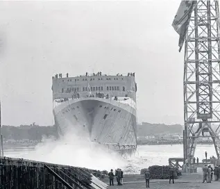  ?? ?? The QEII hits the water as it is launched from the John Brown yard at Clydebank.