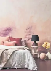  ?? ?? This hand-painted finish is achieved with a wall painted in Resene Wax Flower with brushstrok­e effect in Resene Cab Sav and Resene FX Paint Effects medium mixed with Resene Scotch Mist. Table from Good Form, bedding from Foxtrot Home, cushions from Mulberi.