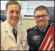  ??  ?? Dr. Davey Daniel with Redcoat Marching Band member Hunter Moreland, who showed his spirit even while getting treatment.