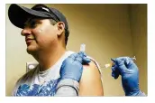  ?? RICARDO B. BRAZZIELL / AMERICANST­ATESMAN ?? Willie Chavez receives a flu shot from nurse Cynthia Smith on Wednesday at South Austin Regional Clinic.