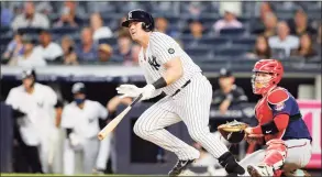  ?? Jim McIsaac / Getty Images ?? Luke Voit of the New York Yankees follows through on his third-inning, two-run double against the Minnesota Twins at Yankee Stadium on Thursday in New York.