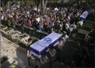  ?? ?? Israeli soldiers and mourners carry the flag-draped coffins of Hillel Yaniv, 21, and Yagel Yaniv, 19, during their funeral Monday at Israel’s national cemetery in Jerusalem. (AP/Ohad Zwigenberg)