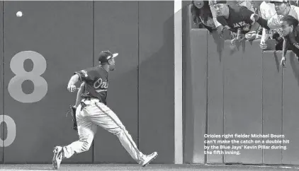  ?? NATHAN DENETTE/ASSOCIATED PRESS ?? Orioles right fielder Michael Bourn can’t make the catch on a double hit by the Blue Jays’ Kevin Pillar during the fifth inning.