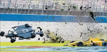  ?? Will Lester Associated Press ?? THE BACK END of Ryan Briscoe’s car disintegra­tes after his collision with Ryan Hunter-Reay on final lap.