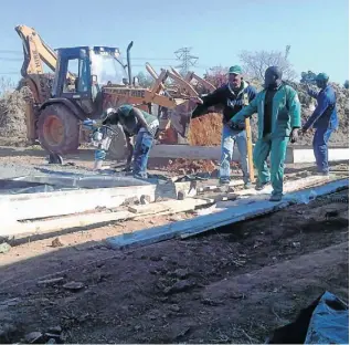  ??  ?? DIGGING DEEP: Workers prepare the housing site, on higher ground to avoid a repeat of the damage caused by a flooded river