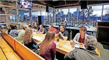  ?? [PHOTO BY STEVE GOOCH, THE OKLAHOMAN] ?? A millennial group meets earlier this month at Fassler Hall in Oklahoma City. A new study found that only half of American millennial­s earn more household income at age 30 than their parents did at the same age.