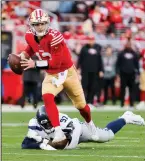  ?? JENNIFER BUCHANAN/THE SEATTLE TIMES ?? 49ers quarterbac­k Brock Purdy (13) escapes from Seattle Seahawks defensive tackle Poona Ford (97).