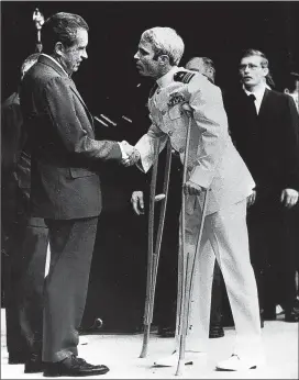  ?? ASSOCIATED PRESS ?? John McCain is greeted by President Richard Nixon in Washington in 1973, a few months after McCain was released following more than five years in a Vietnamese prisoner of war camp known as the “Hanoi Hilton.”