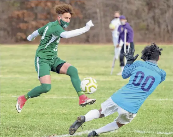  ?? James Franco / Special to the Times Union ?? Shenendeho­wa senior Darien Espinal beats CBA keeper Adrian Torres for a goal during the Suburban Council Tournament final at Shenendeho­wa High School on Saturday. The first-half score didn’t hold up, but the Plainsmen rallied twice in the second half to capture the crown.