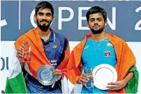  ?? PTI ?? Singapore Open men’s singles champion B Sai Praneeth (right) and runner-up Kidambi Srikanth pose with their tropies. —