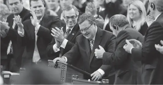  ?? FRED CHARTRAND/ THE CANADIAN PRESS FILES ?? Former minister of finance Jim Flaherty is applauded by his caucus as he arrives to table the budget in the House of Commons on Parliament Hill last Feb. 11.