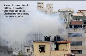  ?? ?? Scene of terror: Smoke billows from the upper floors of the Chabad House during the 2008 attacks