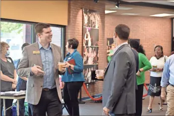  ?? Blake Silvers ?? Peter Coombe from Calhoun City Schools chats with fellow business, education and healthcare leaders from around the are at the Gordon County Chamber of Commerce State of the Industry Workforce Summit on Thursday during a meet-and-greet session.