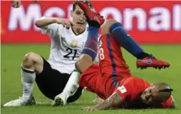  ?? SERGEI GRITS/THE ASSOCIATED PRESS ?? Chile’s Arturo Vidal, right, is tackled by Germany’s Sebastian Rudy during the Confederat­ions Cup final at St. Petersburg, Russia, on Sunday.