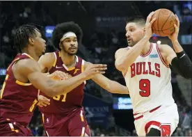  ?? TONY DEJAK - THE ASSOCIATED PRESS ?? Chicago Bulls’ Zach LaVine (8) drives past Cleveland Cavaliers’ Isaac Okoro (35) and Jarrett Allen (31) in the first half of an NBA basketball game, Wednesday, Dec. 8, 2021,
in Cleveland.