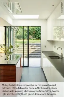  ??  ?? Mulroy Architects are responsibl­e for the renovation and extension of this Edwardian home in North London. Sleek kitchen units featuring white glossy surfaces help to bounce light from the rooflight and glazed door around the space