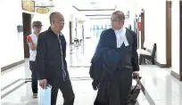  ??  ?? Jasnih (third left) leaving the courtroom with his counsel Hamid (right) after his trial yesterday.