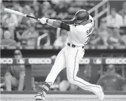  ?? LYNNE SLADKY/AP ?? The Marlins’ Jesus Sanchez hits a two-run home run during the first inning of their game against the Reds on Sunday in Miami.