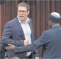  ??  ?? ‘MAN OF TRUTH’: Likud MP Oren Hazan is escorted out of the parliament hall by ushers. Mr Hazan has faced accusation­s of assault, sexual harassment, pimping and supplying drugs.