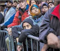  ?? AP/ANDRES KUDACKI ?? People listen to speakers Sunday in Times Square in New York during a rally in support of Muslim Americans and in protest of President Donald Trump’s immigratio­n policies.