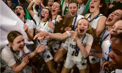  ?? BARRY CHIN/GLOBE STAFF ?? The Bishop Feehan girls’ basketball team was in a mood to celebrate its Division 1 title.