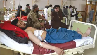  ??  ?? QUETTA: A Pakistani victim of cross border firing rests at a hospital in Quetta, Pakistan yesterday. — AP