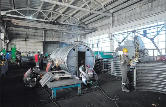  ?? Thibault Camus
The Associated Press ?? Workers cut and weld metal as they build a shelter Thursday at a Metinvest company plant in Kryvyi Rih, Ukraine.