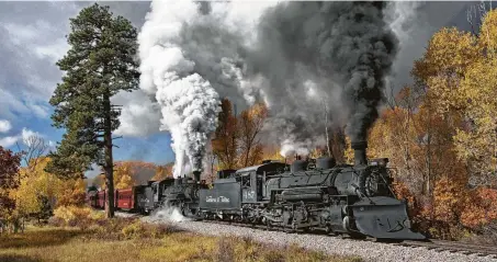  ?? Photos by Justin Franz / Washington Post ?? A pair of Cumbres &amp; Toltec Scenic steam locomotive­s pull a passenger train near Chama, N.M.