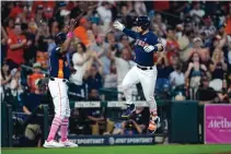  ?? DAVID J. PHILLIP/ASSOCIATED PRESS ?? Houston’s Alex Bregman, right, celebrates with third base coach Gary Pettis after hitting a home run Detroit. The Astros have won seven straight games.