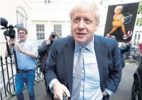  ?? KIRSTY WIGGLESWOR­TH THE ASSOCIATED PRESS ?? Boris Johnson launched his party leadership campaign in London this week, which could make him prime minister. Behind him, a protester holds a satirical sign.