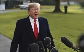  ??  ?? President Donald Trump speaks to reporters before boarding Marine One on the South Lawn of the White House in Washington, Monday, before heading to Utah. Trump will be announcing plans to scale back two sprawling national monuments in Utah, responding...