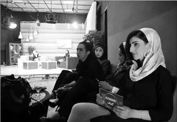  ??  ?? Afghan presenters (back, left) record their morning programme as others wait at the Zan TV (Women’s TV) station in Kabul.