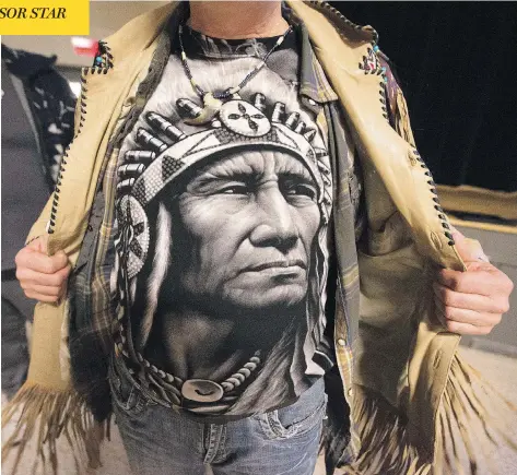  ?? CHRISTINNE MUSCHI /NATIONAL POST ?? Robin Robichaud shows his T-shirt after a recent meeting of the Wobtegwa aboriginal community in Sherbrooke, Que.