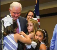  ??  ?? Former US attorney general Jeff Sessions hugs his family after his speech following the Alabama Republican primary run-off election