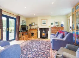  ??  ?? The second reception is a family room with solid-fuel stove and French doors to the back garden