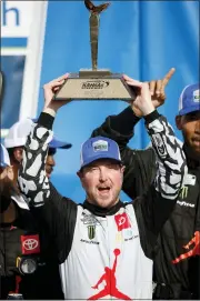  ?? COLIN E. BRALEY — THE ASSOCIATED PRESS ?? Kurt Busch celebrates winning Sunday’s NASCAR Cup Series race at Kansas Speedway. Kyle Larson was second.