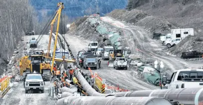  ?? REUTERS ?? The last section of pipeline is assembled Feb. 18 on the Trans Mountain pipeline expansion project before operations are expected to begin in the second quarter of 2024, near Laidlaw, B.C.