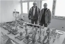  ?? Rafal Niedzielsk­i/Associated Press ?? Around 400 items, including menorahs and hanukkiahs, were found during a home renovation in the Polish city of Lodz.