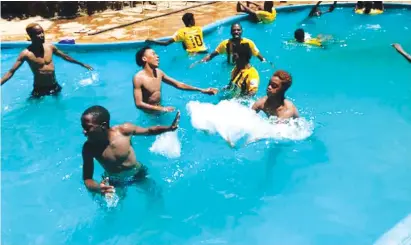  ??  ?? COOLING . . . Manica Diamonds’ players enjoy a swimming break during their ongoing week-long pre-season camp at Lake Mutirikwi OFF in Masvingo.
