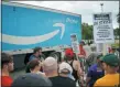  ?? GLEN STUBBE — STAR TRIBUNE VIA AP ?? Workers, supporters and activists picket outside the Amazon fulfillmen­t Center in Shakopee, Minn. on the afternoon of Prime Day on Monday. Trucks were allowed through the picket line after a brief delay.